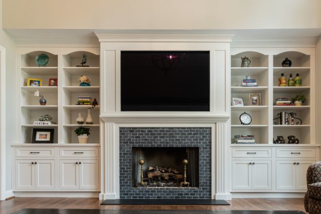Family room built in storage and fireplace surround