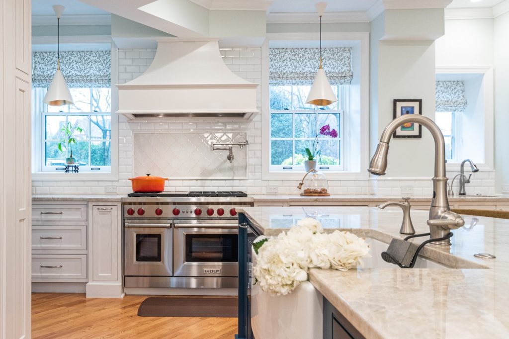 airy transitional kitchen range and custom range hood